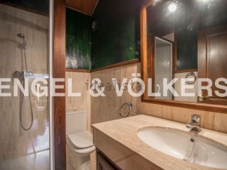 This stunning bathroom boasts a spacious shower, modern sink, and elegant toilet.