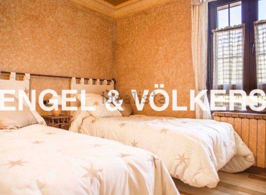 Charming bedroom with twin beds, featuring a rustic yet elegant design.