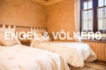 Charming bedroom with twin beds, featuring a rustic yet elegant design.