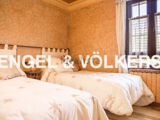 Charming bedroom with twin beds, featuring a rustic yet elegant design.
