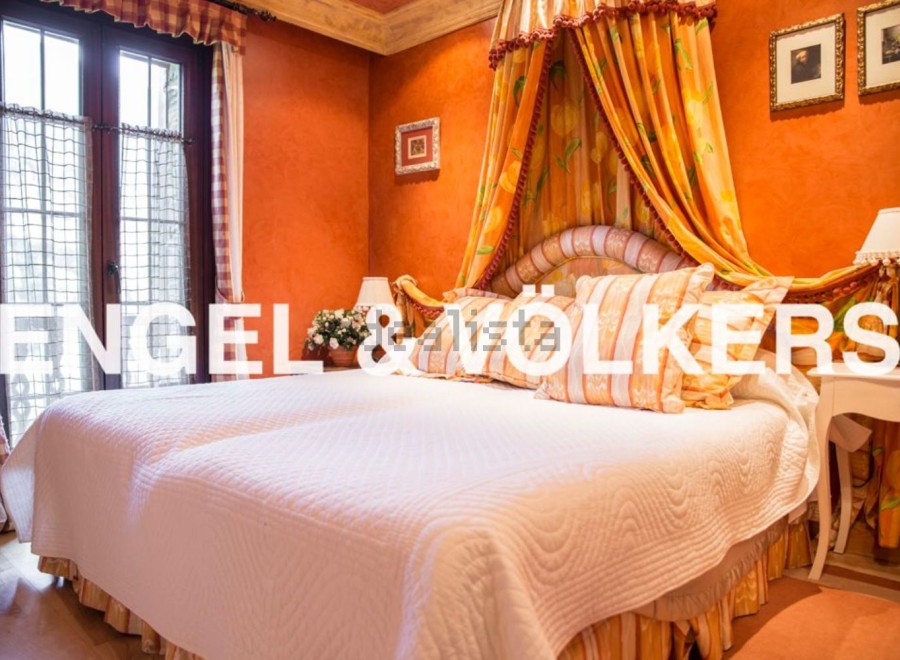 Luxurious bedroom with a stunning four-poster bed and beautiful orange walls.