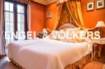 Luxurious bedroom with a stunning four-poster bed and beautiful orange walls.