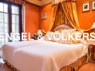 Luxurious bedroom with a stunning four-poster bed and beautiful orange walls.