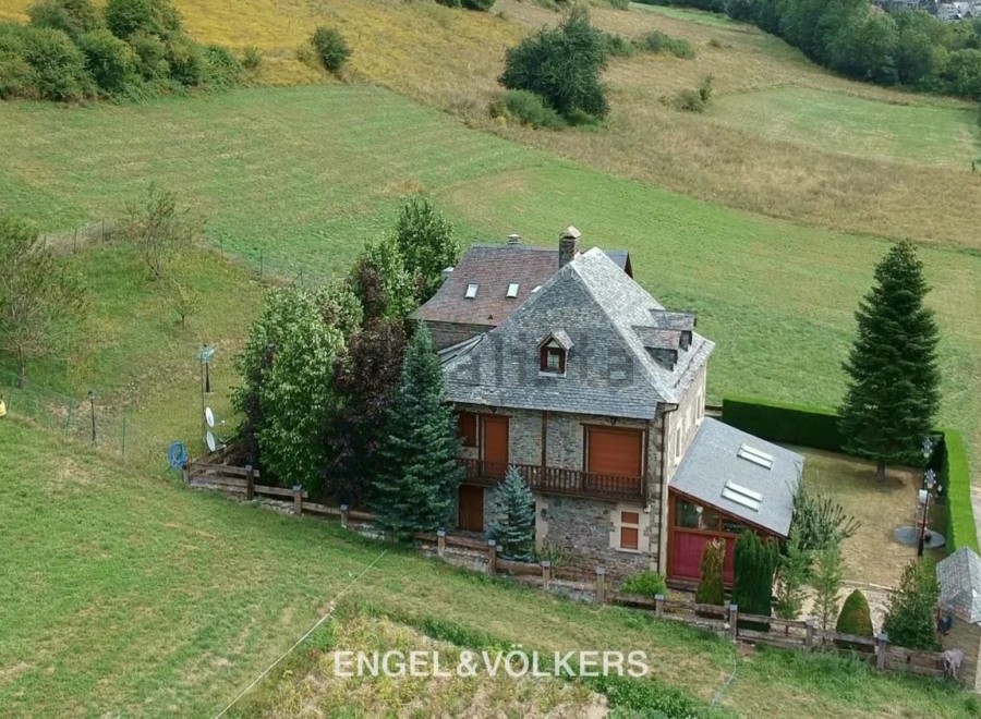 Nestled in a serene landscape, this charming stone house offers breathtaking views.