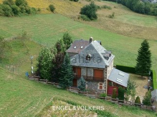 Nestled in a serene landscape, this charming stone house offers breathtaking views.