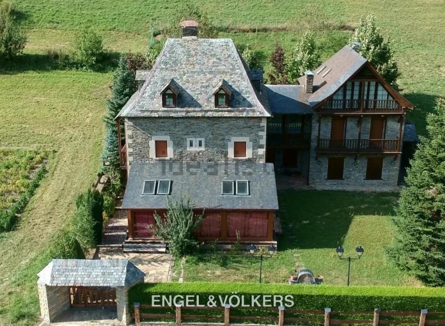 This stunning stone property boasts a main house with a slate roof, plus a charming secondary building.