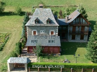 This stunning stone property boasts a main house with a slate roof, plus a charming secondary building.