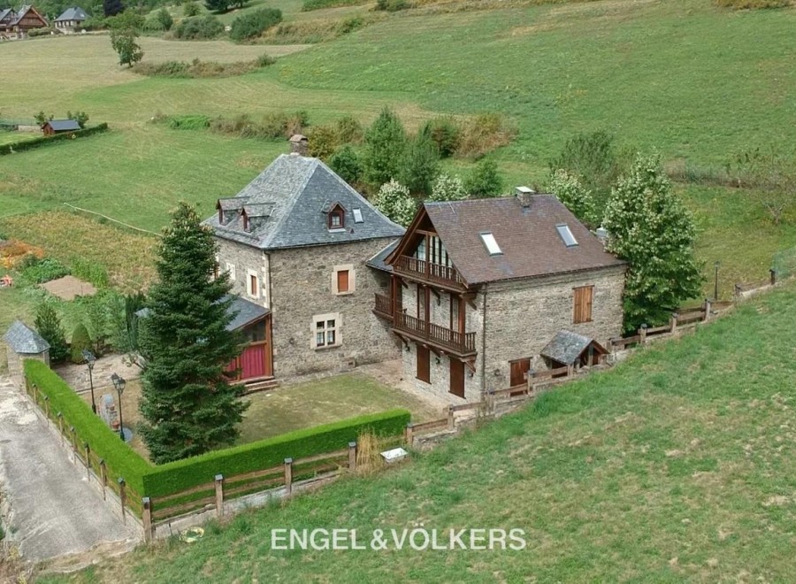 This stunning property boasts two charming stone houses nestled in a picturesque countryside setting.