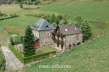 This stunning property boasts two charming stone houses nestled in a picturesque countryside setting.