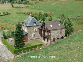 This stunning property boasts two charming stone houses nestled in a picturesque countryside setting.