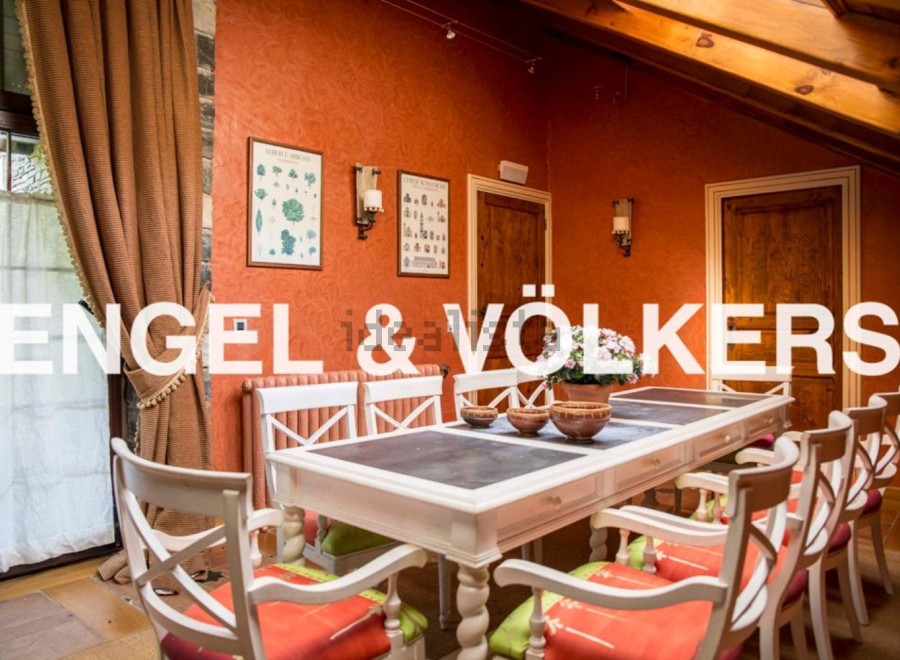 This stunning property boasts a spacious dining area with a large table perfect for family gatherings.