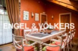 This stunning property boasts a spacious dining area with a large table perfect for family gatherings.