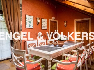 This stunning property boasts a spacious dining area with a large table perfect for family gatherings.