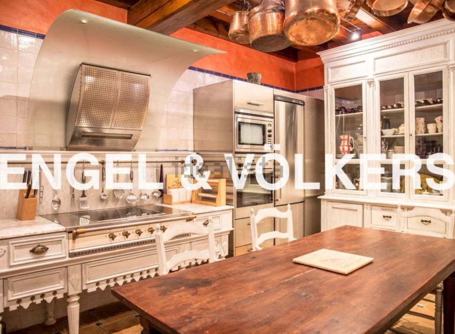 This stunning kitchen boasts a unique blend of modern appliances and antique charm.
