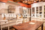 This stunning kitchen boasts a unique blend of modern appliances and antique charm.