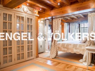 This luxurious bedroom boasts a stunning four-poster bed, custom-built wardrobes, and exquisite wooden beams.