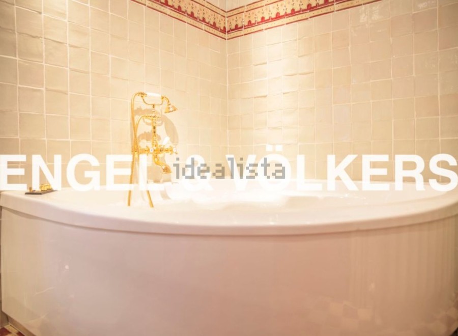 Indulge in luxury with this stunning bathroom featuring a freestanding bathtub and elegant gold fixtures.