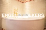 Indulge in luxury with this stunning bathroom featuring a freestanding bathtub and elegant gold fixtures.