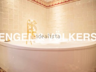 Indulge in luxury with this stunning bathroom featuring a freestanding bathtub and elegant gold fixtures.