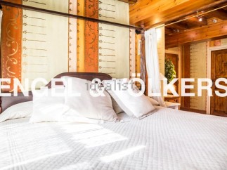 This luxurious bedroom boasts a stunning hand-painted headboard and a comfortable four-poster bed.