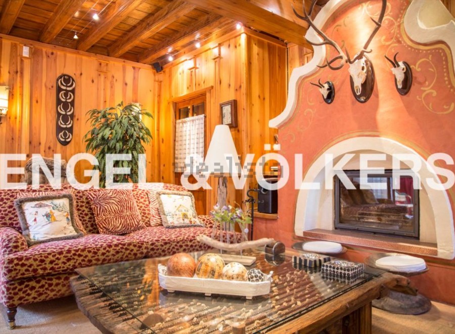 This stunning chalet boasts a cozy living room with a unique fireplace, perfect for relaxing winter evenings.