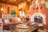 This stunning chalet boasts a cozy living room with a unique fireplace, perfect for relaxing winter evenings.