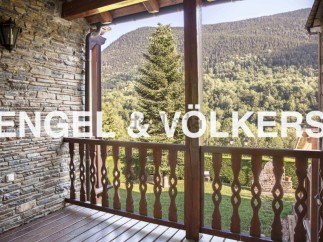 Mountain views from a charming balcony with wooden railings.