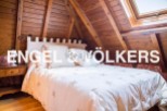 Cosy attic bedroom with wooden beams and skylight.