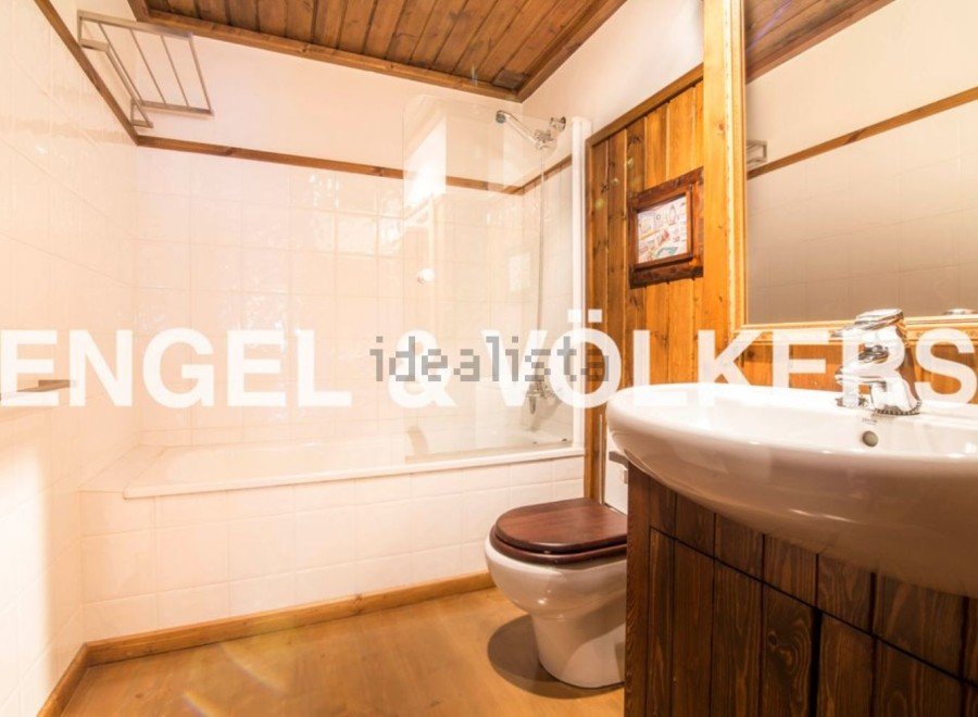 Charming bathroom with wooden accents and a bathtub.