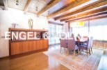 This stunning property boasts a spacious dining area with a wooden ceiling and large windows, creating a bright and airy atmosphere.