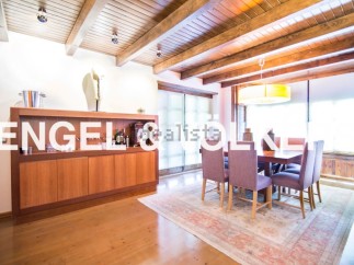 This stunning property boasts a spacious dining area with a wooden ceiling and large windows, creating a bright and airy atmosphere.
