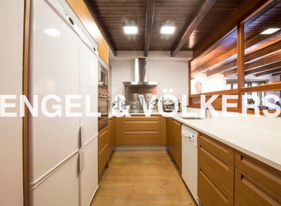 Stunning kitchen with modern appliances and wooden cabinetry.