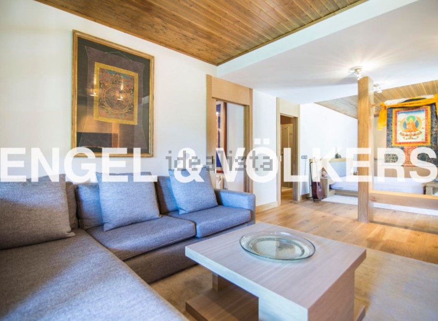 This stunning apartment boasts a spacious living area with a comfortable sectional sofa and a stylish coffee table.