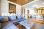This stunning apartment boasts a spacious living area with a comfortable sectional sofa and a stylish coffee table.