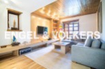 Stunning mountain view living room with L-shaped sofa and built-in entertainment center.