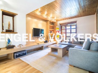 Stunning mountain view living room with L-shaped sofa and built-in entertainment center.