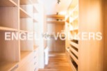 Spacious walk-in closet with ample shelving and drawer space.