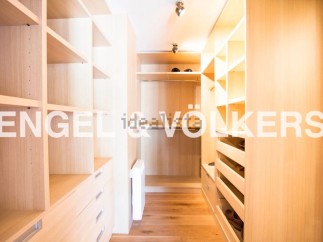 Spacious walk-in closet with ample shelving and drawer space.