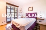 This charming bedroom boasts a comfortable double bed, large windows offering stunning views, and plenty of natural light.