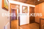 This stunning property boasts a spacious hallway with rich wooden flooring and doors, creating a warm and inviting atmosphere.