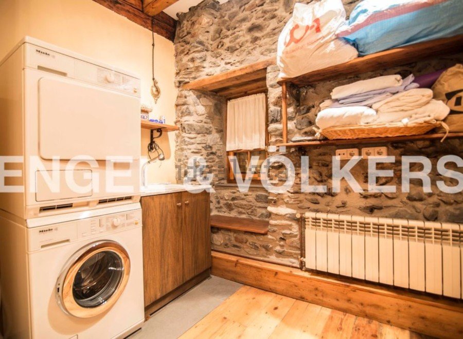 Rustic charm meets modern convenience in this unique laundry room.
