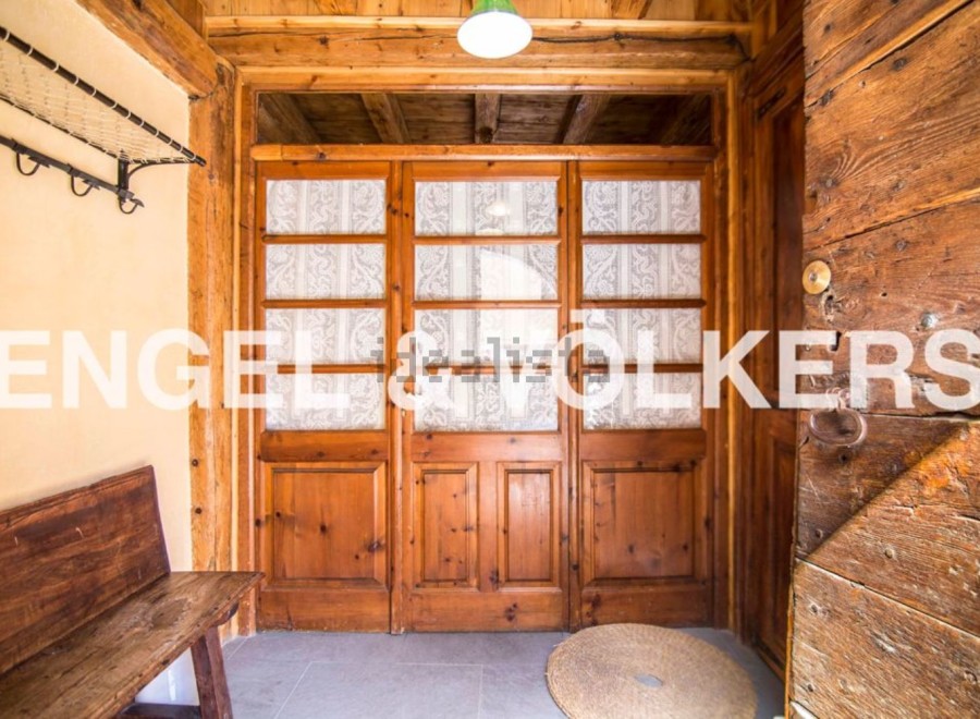 Charming wooden doors welcome you into this rustic property, showcasing its unique character and craftsmanship.