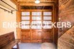 Charming wooden doors welcome you into this rustic property, showcasing its unique character and craftsmanship.