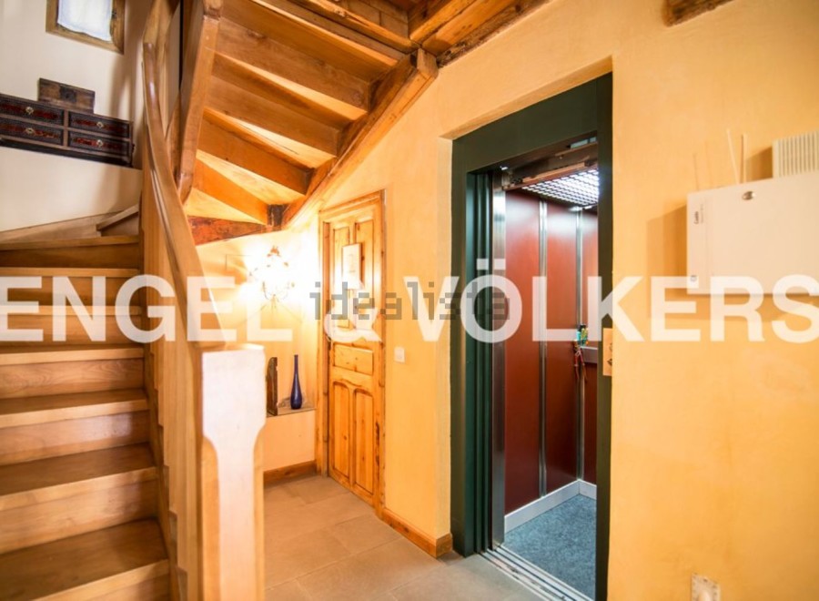 This stunning property boasts a beautiful wooden staircase and a convenient elevator, perfect for easy access to all levels.
