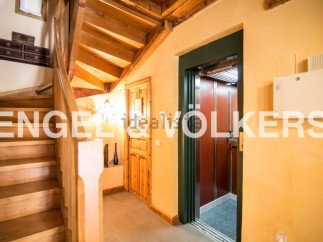 This stunning property boasts a beautiful wooden staircase and a convenient elevator, perfect for easy access to all levels.