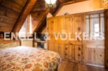 Charming rustic bedroom with wooden beams and built-in wardrobe.