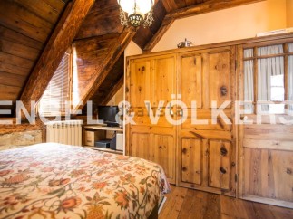 Charming rustic bedroom with wooden beams and built-in wardrobe.