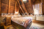Rustic charm meets modern comfort in this unique attic bedroom.