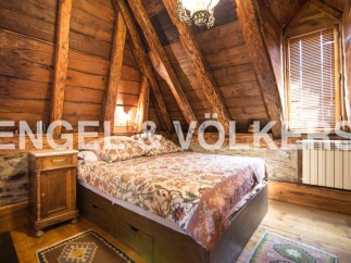Rustic charm meets modern comfort in this unique attic bedroom.