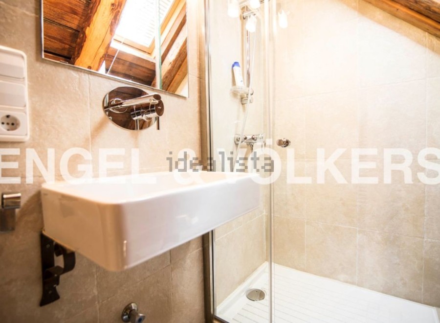 Charming bathroom with modern fixtures and a spacious shower stall.